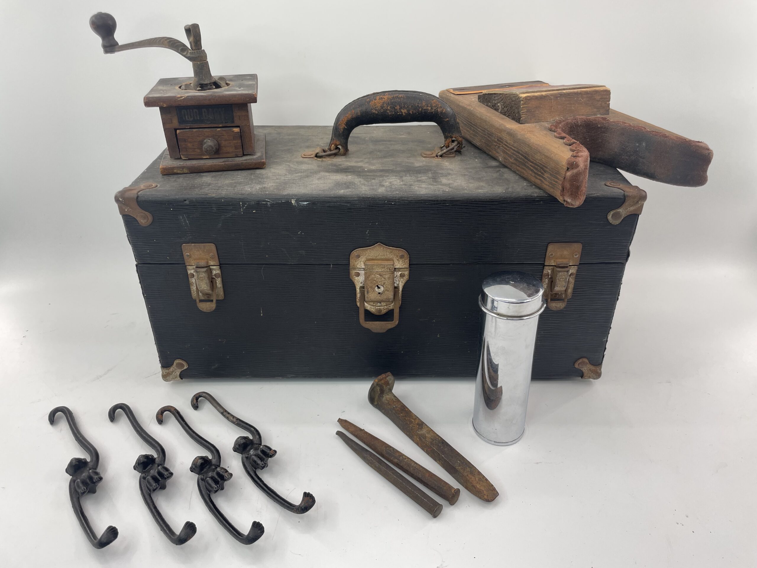 Lot # 83 – Antique Doctors contraption box, cast iron hanging monkey hooks, small grinder & more!