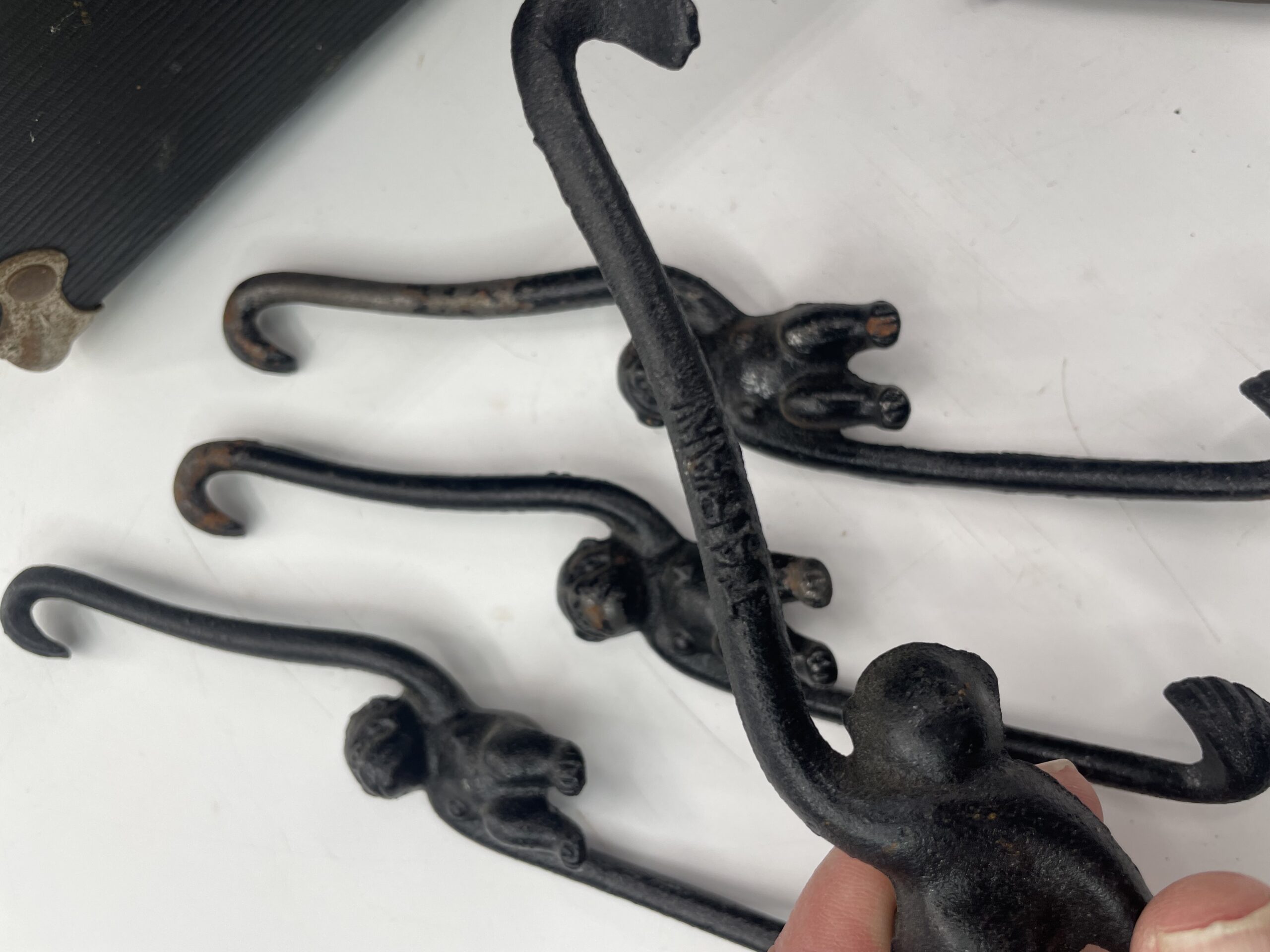 Lot # 83 – Antique Doctors contraption box, cast iron hanging monkey hooks, small grinder & more! - Image 3