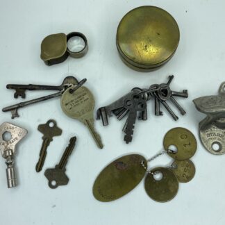 Lot # 81 - Trinket box lot. Vintage Alcatraz prison tags, old keys, casino Monte Carlo brass tin, Coca-Cola wall bottle opener, & more