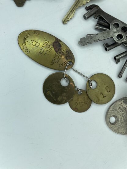 Lot # 81 – Trinket box lot. Vintage Alcatraz prison tags, old keys, casino Monte Carlo brass tin, Coca-Cola wall bottle opener, & more - Image 2
